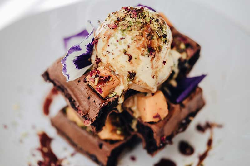 LUCUMA MATATA – chocolate waffle with fresh mango, dulce de leche, pistachio, petals, date syrup and lotus ice cream AED 57 (V/N)
لوكوما ماتاتا - المكون من وافل بالشوكولاتة مع المانجو الطازج وحلوى دولسي دي ليتشي والفستق وزهرة البتلة وشراب التمر والآيس كريم واللوكوما 57 درهمًا